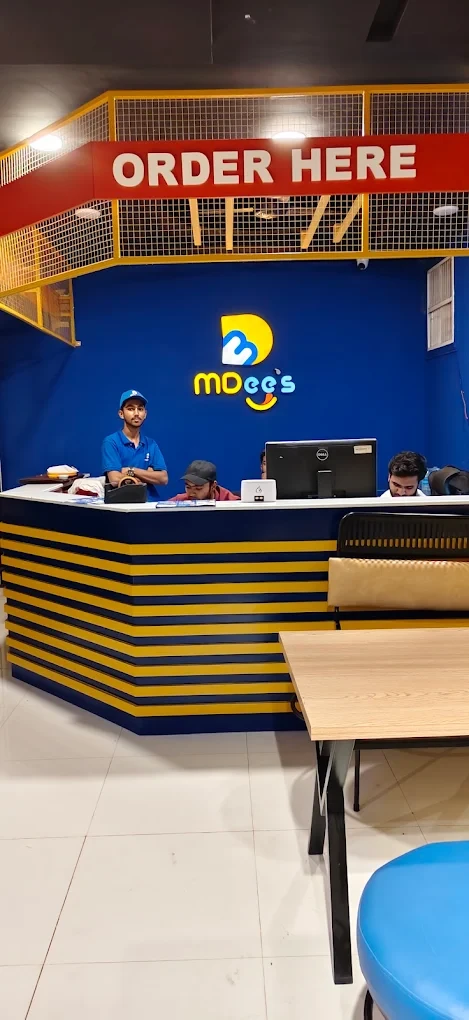MDee's order counter with staff and brand signage