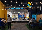 MDee's branch exterior and outdoor seating patio at night